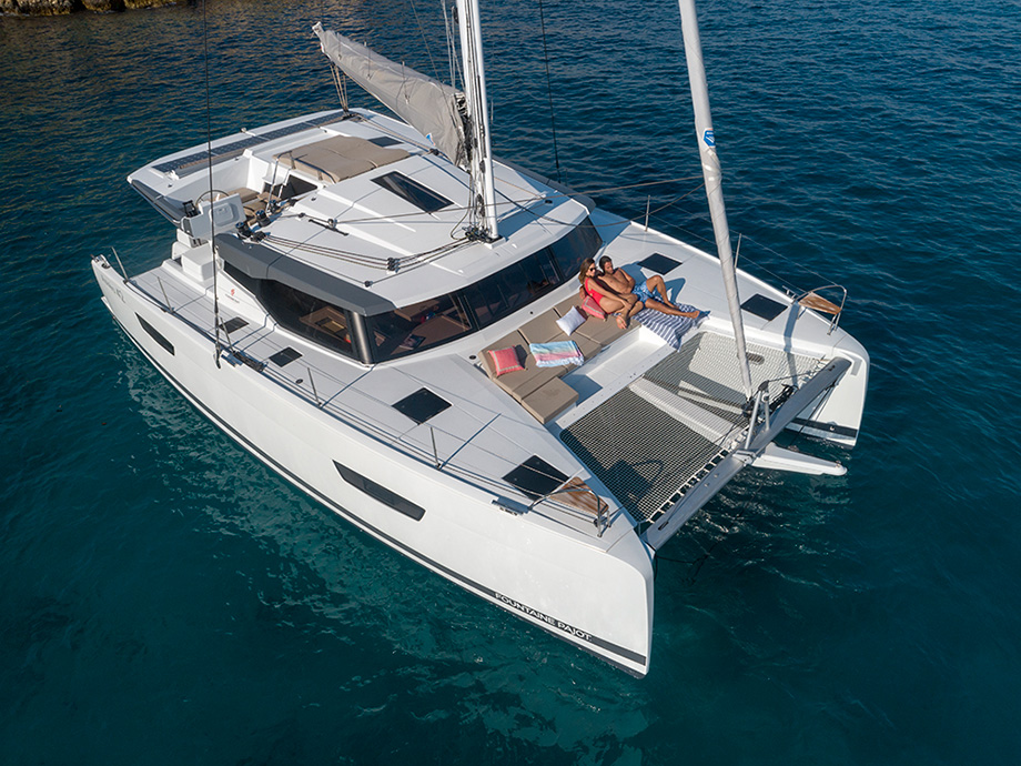 Catamaran Astréa 42 - birds eye view with two people lying on the deck